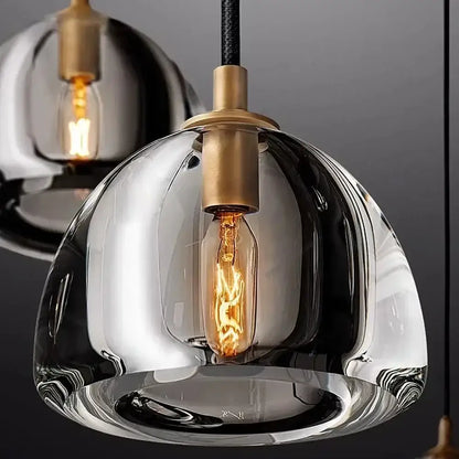 A sleek decorbites black brass retro pendant light with hand-blown glass and exposed edison bulb for dining room