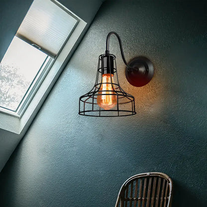 Retro black cage guard wall sconce with black wrought iron cage design housing an exposed filament bulb for decorbites black cage decor
