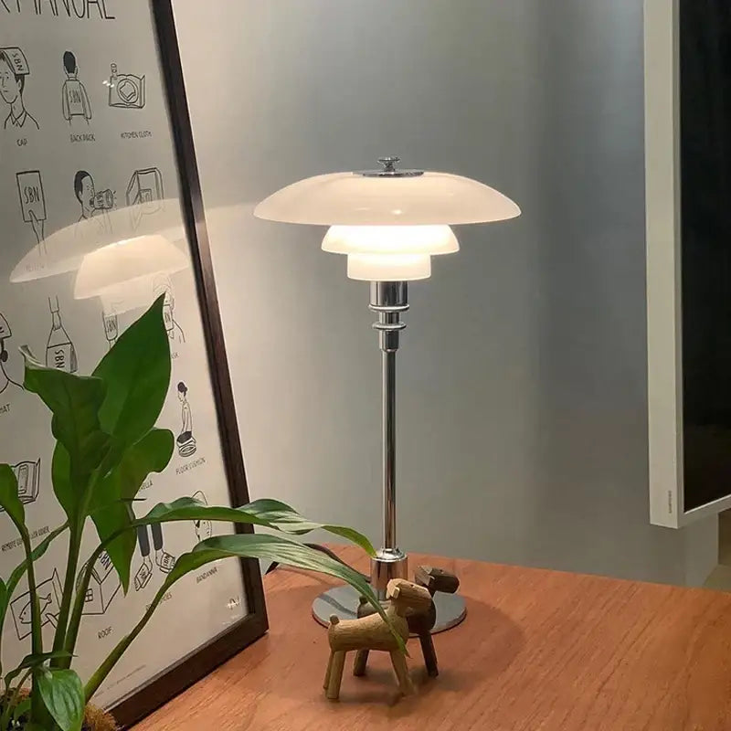 A sleek floor lamp with a white layered opal glass shade and polished chrome stem featuring a retro black glass shade led design