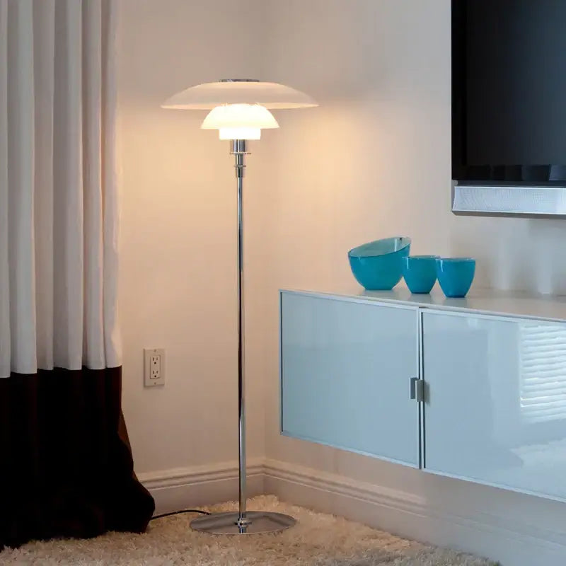 A sleek floor lamp with a polished chrome stand and a white layered glass shade led for modern living rooms