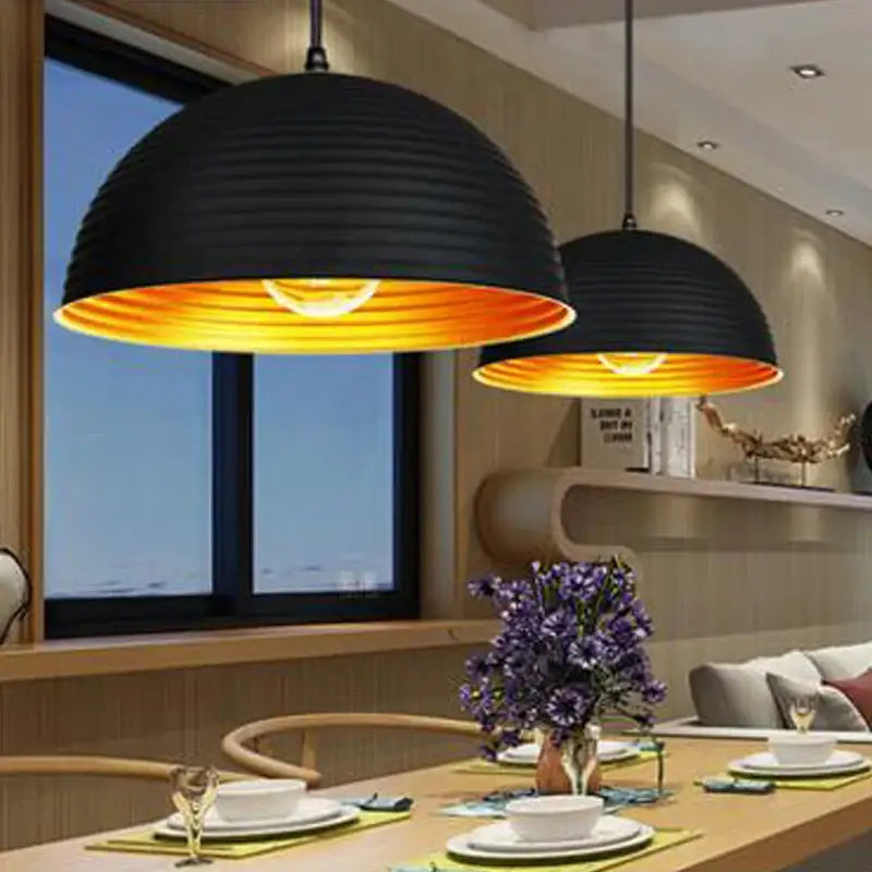 Retro black and gold semicircle pendant light with black pot cover and warm orange interior glow for dining room decorbites black pot