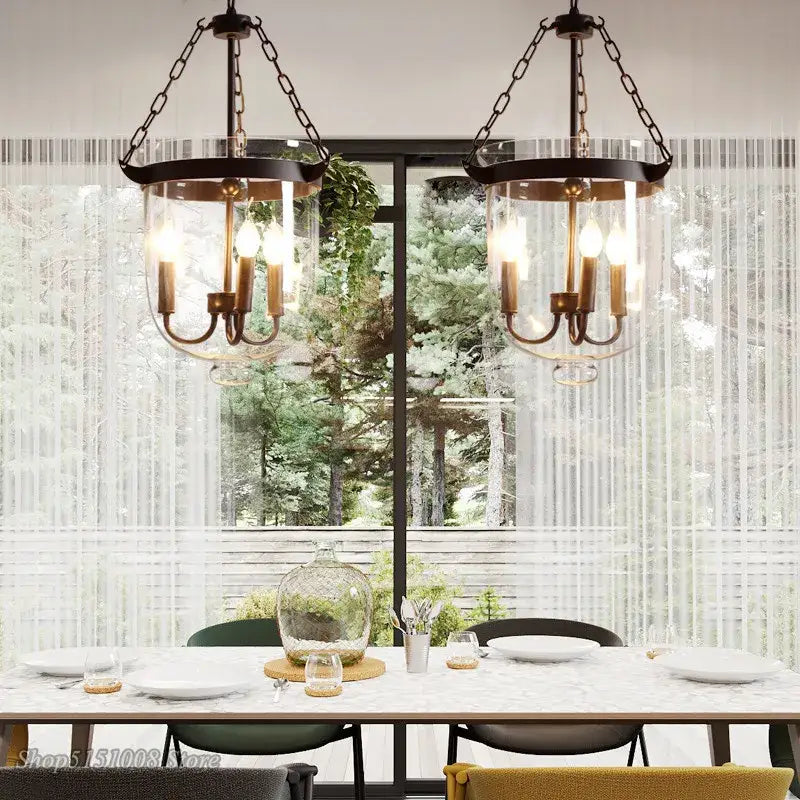 Two vintage-style retro black metal glass bucket pendant lights with brass fixtures and clear glass shades for dining room decorbites glass bucket lighting