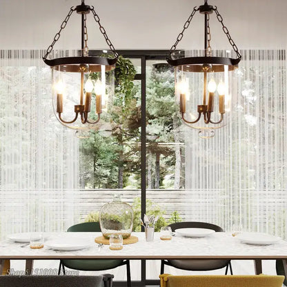 Two vintage-style retro black metal glass bucket pendant lights with brass fixtures and clear glass shades for dining room decorbites glass bucket lighting