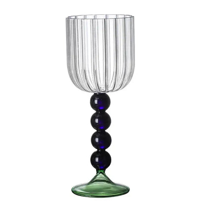 Clear glass wine glass with vertical ribbed texture, blue bead glass twister stem, and green-tinted base for dining