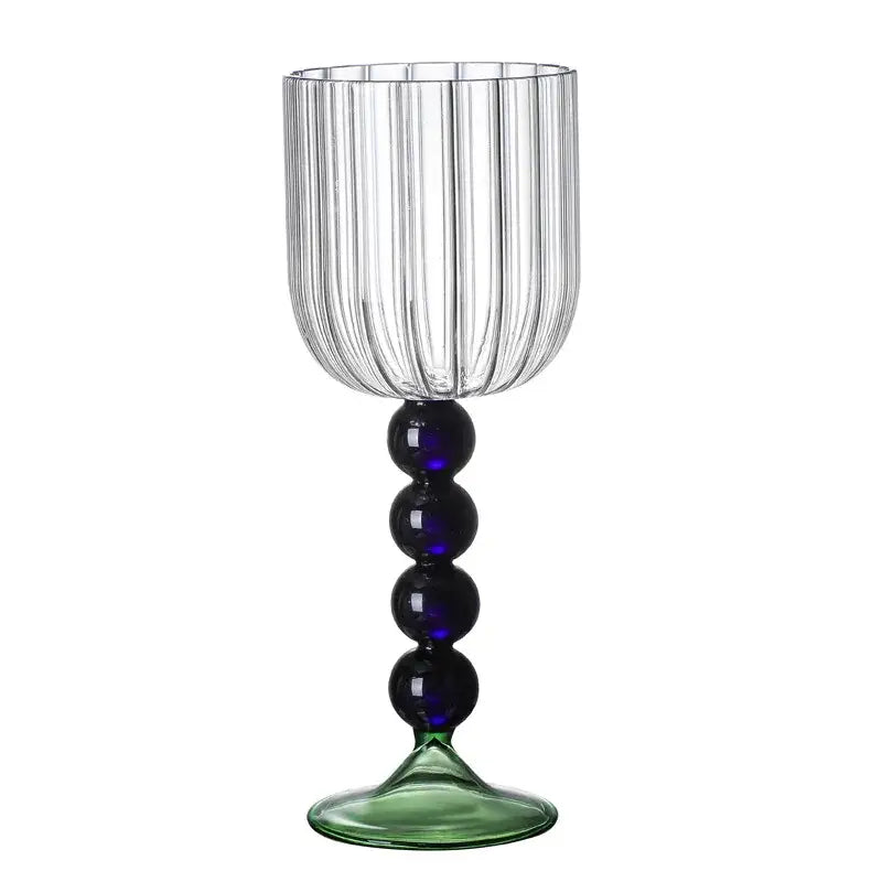 Clear glass wine glass twister with vertical ribbed texture, blue beads on stem, and green-tinted base for dining room use