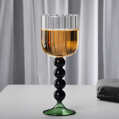 A tall elegant retro blue and green ribbed wine glass twister with black bead stem and glass twister stem design
