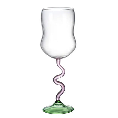 A clear glass wine glass with a twisted lavender glass twister stem and green base for dining room use