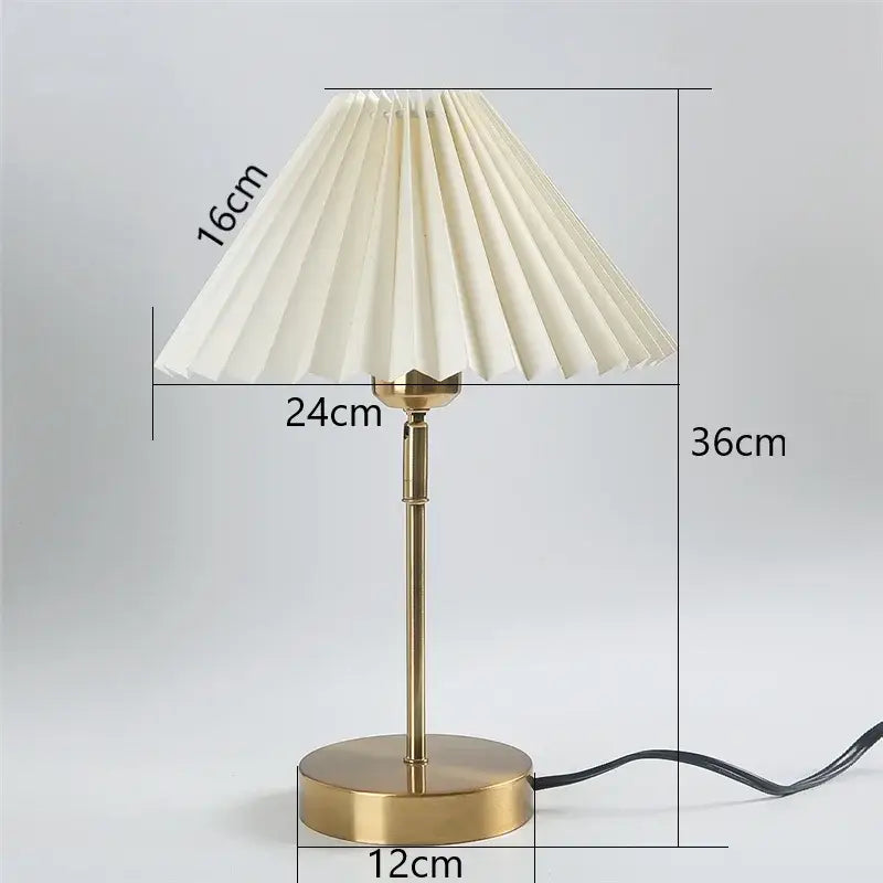 A cream-colored adjustable pleated table lamp with a brass finish and dimensions marked for decorbites adjustable pleated use