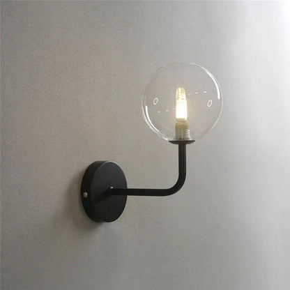Black metal wall lamp with clear glass ball and illuminated filament bulb, perfect decorbites glass ball bedroom lighting