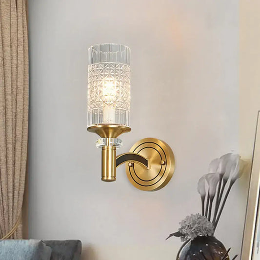 Gold-toned retro brass wall light with faceted crystal glass shade and geometric etching for living room use