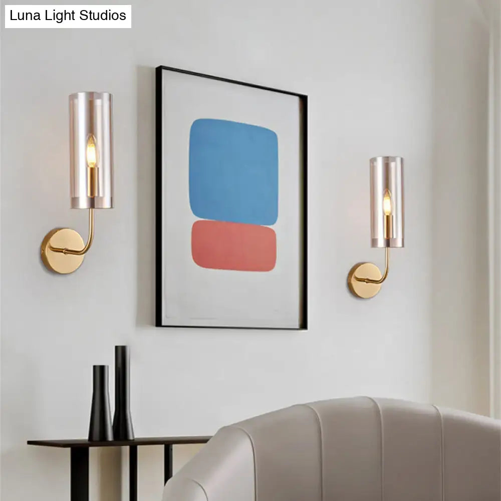 Retro brass wall mount lamp with gold-toned mount and cylindrical frosted glass shades for living room use