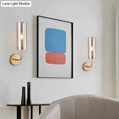 Retro brass wall mount lamp with gold-toned mount and cylindrical frosted glass shades for living room use