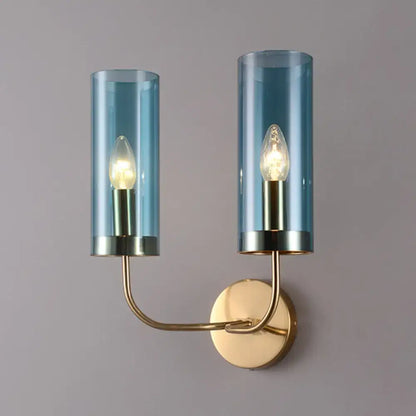 Retro brass wall mount lamp with smoked blue glass shade and brass-finished metal arms for living room use