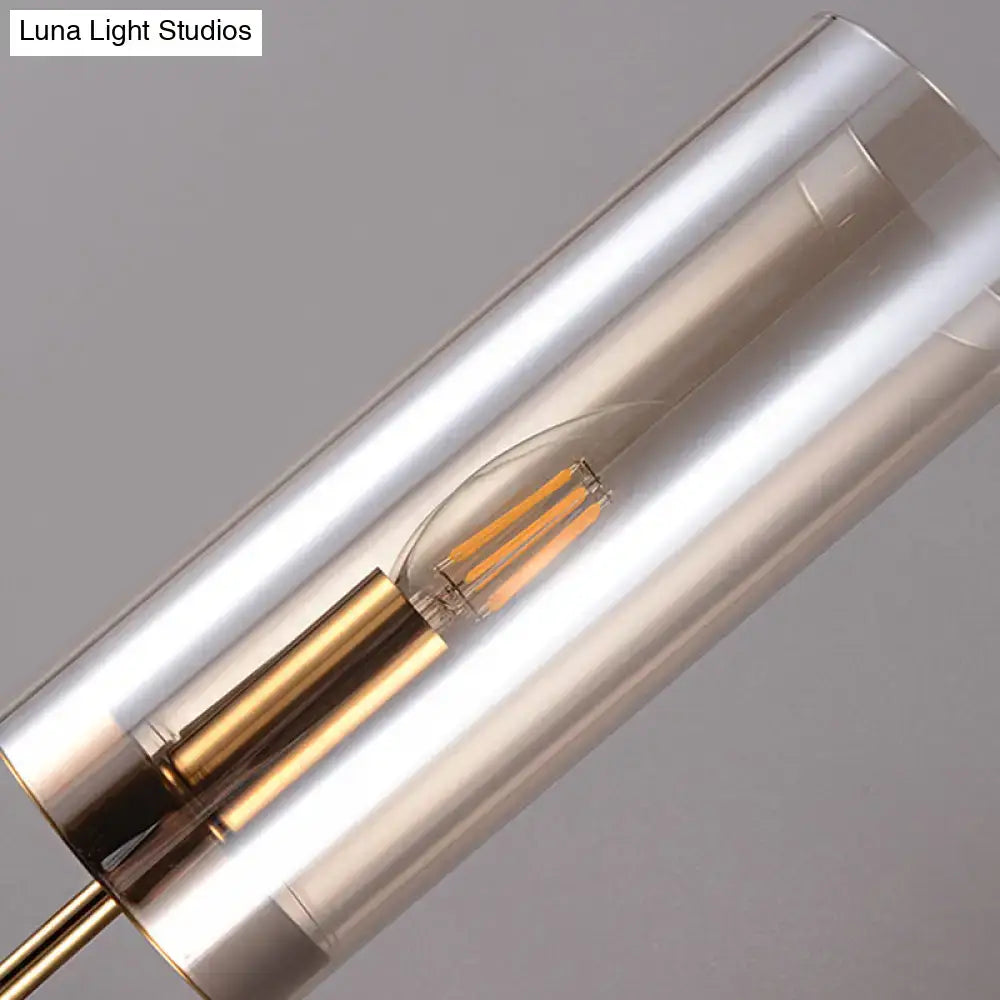 Modern cylindrical wall mount lamp with frosted glass shade brass accents and led filament bulb for living room use