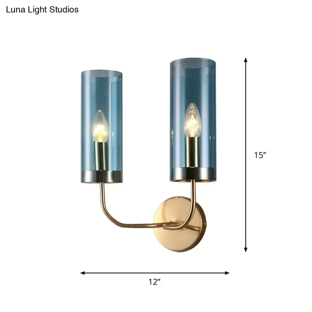 Retro brass wall mount lamp with smoked blue glass shade and brass-finished metal arms for living room use
