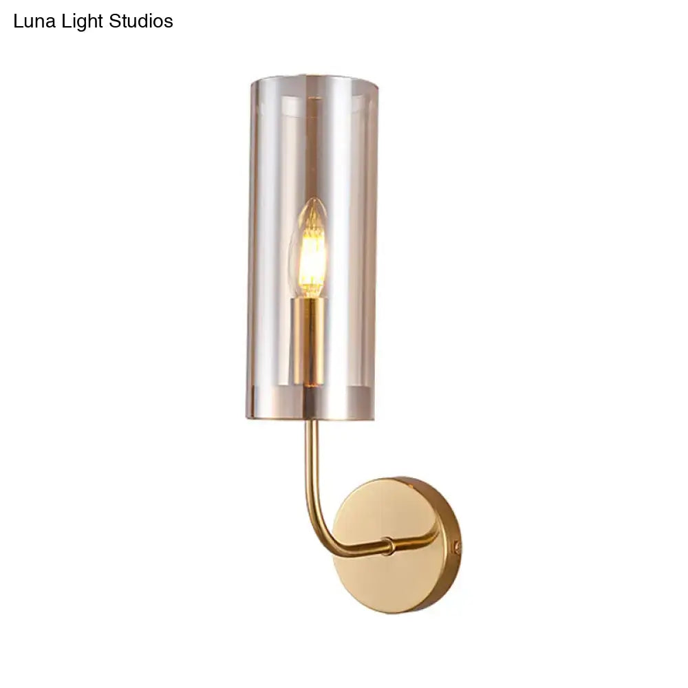 Retro brass wall mount lamp with gold-toned finish and smoked glass shade featuring exposed filament bulb for living room