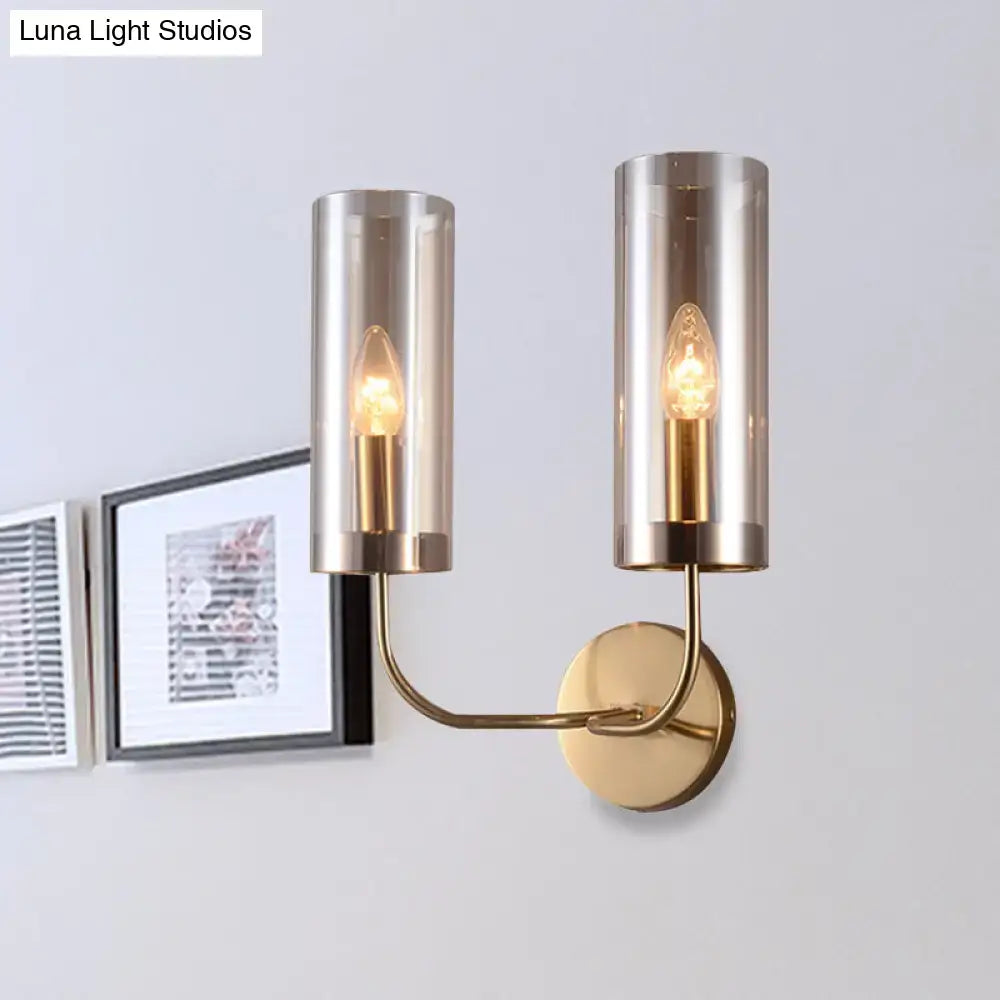 Retro brass wall mount lamp with gold-toned metal and smoked glass shades featuring exposed filament bulbs for living room use