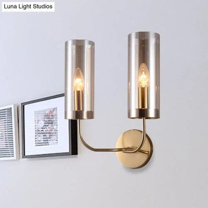 Retro brass wall mount lamp with gold-toned metal and smoked glass shades featuring exposed filament bulbs for living room use