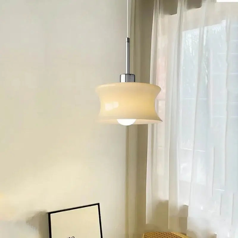Cream-colored translucent glass chandelier with sleek chrome metal stem by decorbites for bedroom pendant lighting