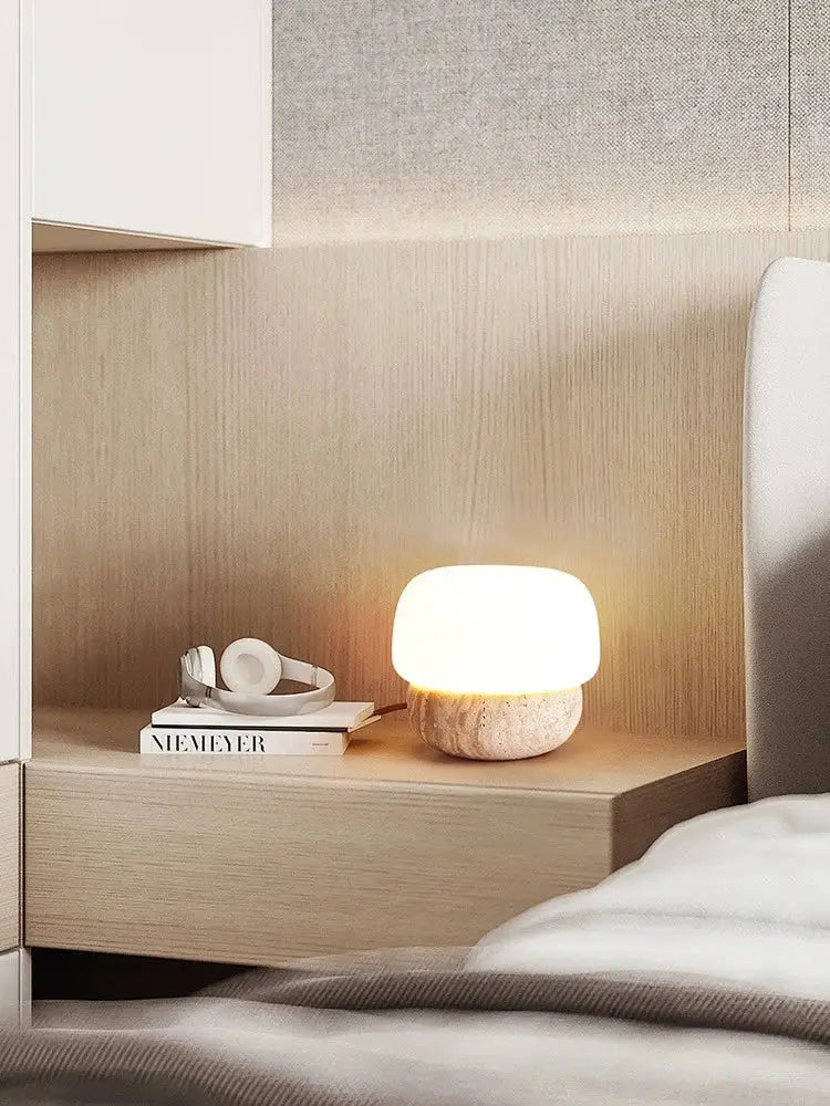 A decorbites cream mushroom table lamp with a smooth white glass top and textured stone base for bedroom decor