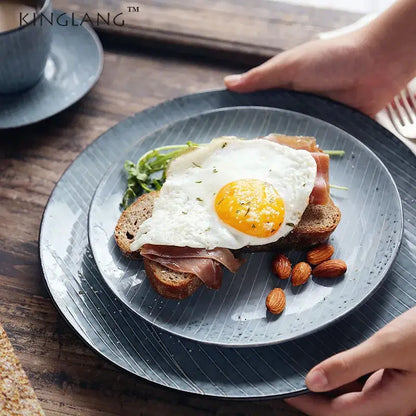Dark gray ceramic dinner plate with subtle vertical ridges and speckled finish from decorbites ceramic dinner collection