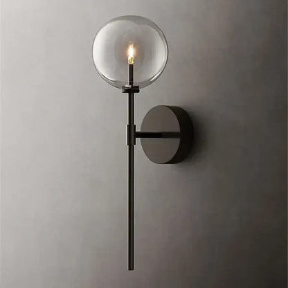 Modern black metal wall sconce with a clear glass ball and exposed filament bulb for retro living room lighting