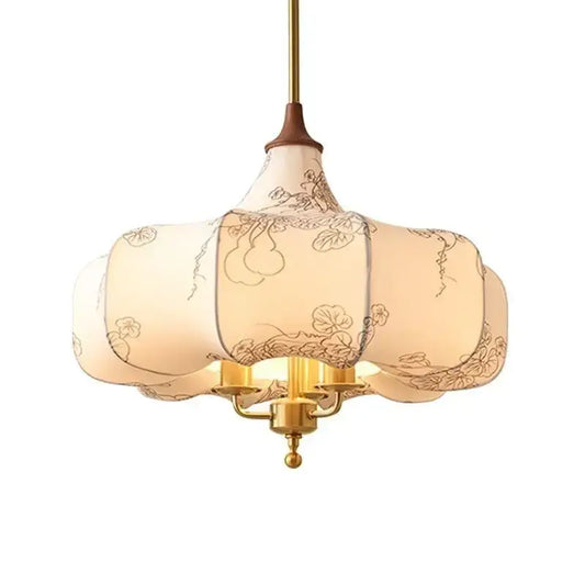 A cream lantern-style pendant light with black floral embroidery and brass frame for decorbites gold lustre retro decor