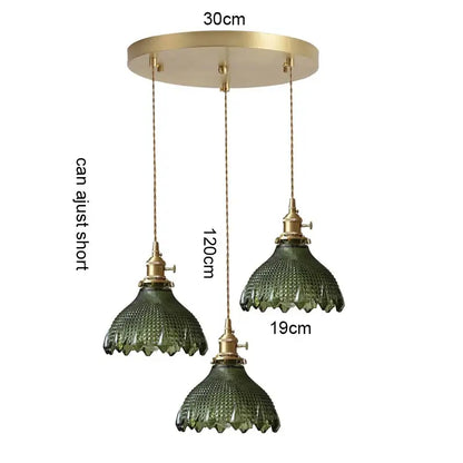 Set of three vintage-style green glass pendant lights with brass fixtures wood accent and adjustable chains for dining room