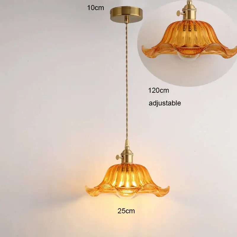 A warm amber glass pendant light with fluted design, brass hardware, and wood accent suitable for dining room with e27 led bulb