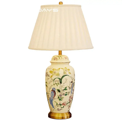Cream-colored ceramic table lamp with retro hand-painted country flower bird motifs and gold-toned metal base decorbites country flower