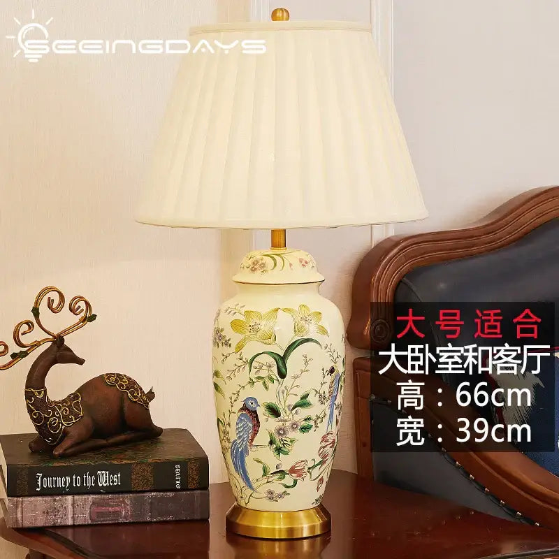 Cream-colored ceramic table lamp with hand-painted country flower bird motifs and gold-toned metal base for decorbites decor