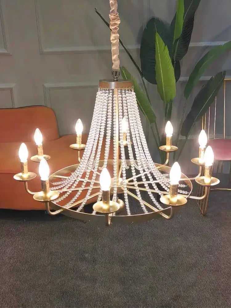 Gold-toned decorbites crystal chandelier with cascading beads and candle-style bulbs for dining room lighting