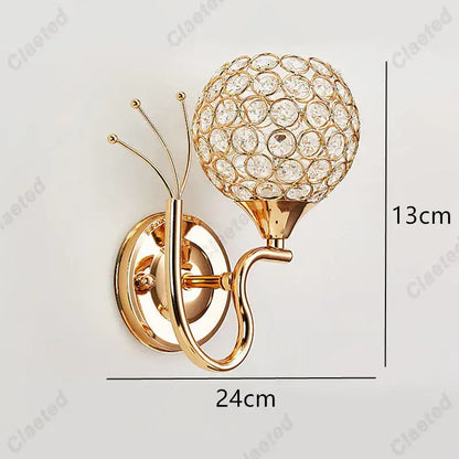 Gold-toned retro industrial wall lamp sconce with spherical crystal globe design for bedroom lighting