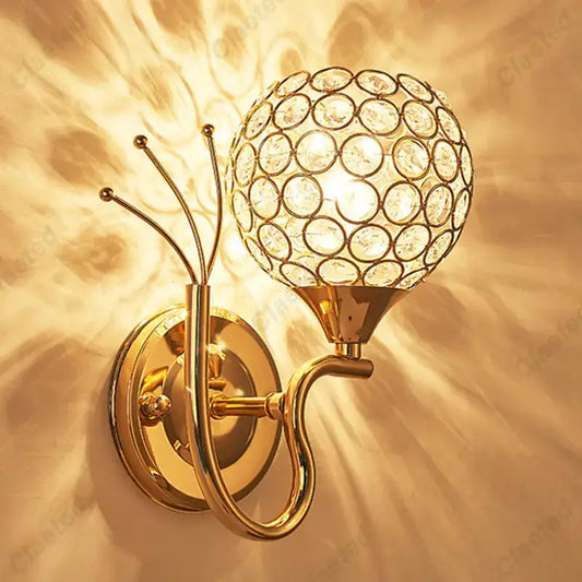 Gold-toned retro industrial wall lamp sconce with spherical crystal globe design for bedroom lighting