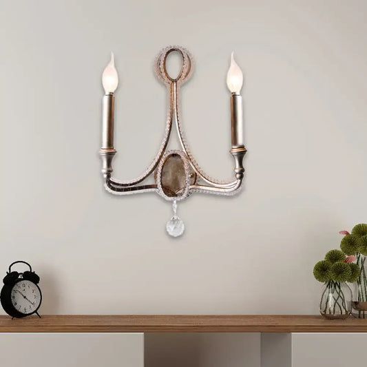 Antique brass two-light wall light with crystal accents and dangling faceted pendant in retro loft fabric aged silver finish