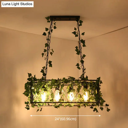 DecorBites™ black retro metal pendant light with rectangular frame, glowing filament bulbs, and hanging green ivy vines