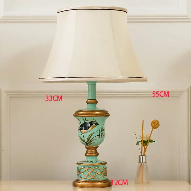 Retro mint green resin table lamp with butterfly detail featuring turquoise ceramic body and off-white fabric shade decorbites green resin