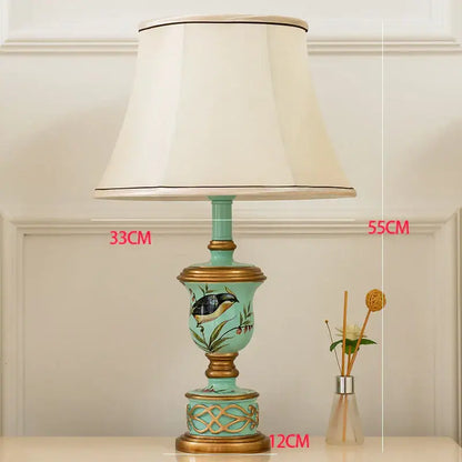 Retro mint green resin table lamp with butterfly detail featuring turquoise ceramic body and off-white fabric shade decorbites green resin