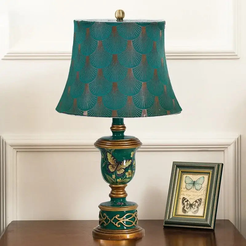Teal and gold ornate decorbites green resin table lamp with scalloped patterned shade and butterfly detail for bedroom decor