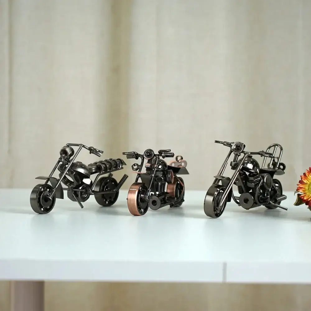 Three miniature metal figurine retro motorcycle models in black matte copper and chrome finishes for living room decor