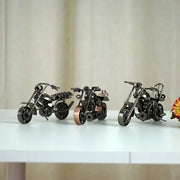 Three miniature metal figurine retro motorcycle models in black matte copper and chrome finishes for living room decor