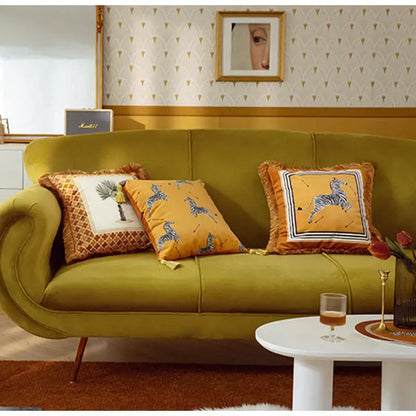 Olive green velvet sofa with curved arms and tapered legs featuring retro mustard and zebra print cushion cover decorbites italian retro