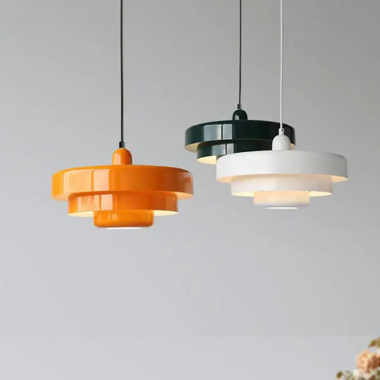 Three tiered metal pendant light in orange white and black for kitchen with retro design and vibrant colors