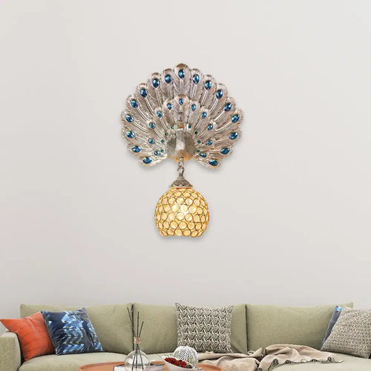 Silver peacock wall lamp with blue gemstone eyes, clear crystal details, golden mosaic shade, and peacock backplate for living room