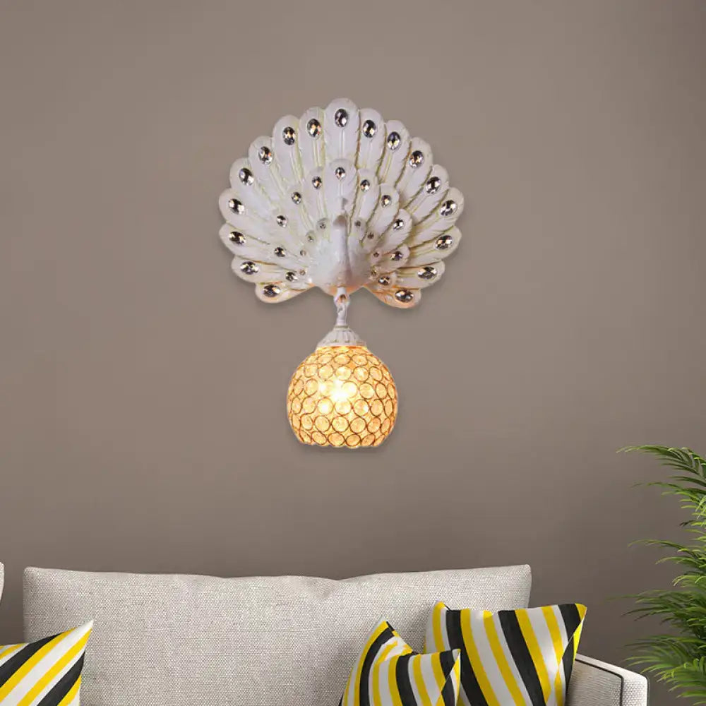 White peacock-shaped wall lamp with silver rhinestones and honey-colored mosaic glass shade featuring clear crystal peacock backplate