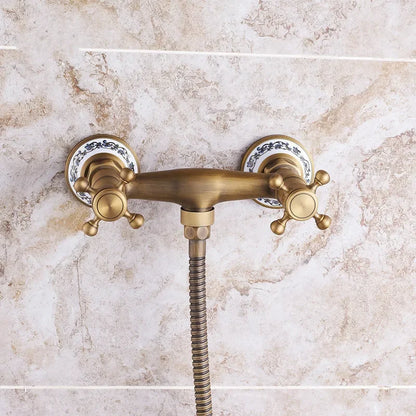 Antique brass double-handle shower faucet with ornate ceramic escutcheons and flexible hose for wall mount use