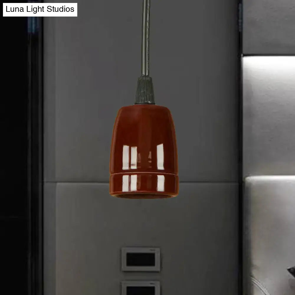 A glossy black red ceramic pendant light with an adjustable cord and sleek metallic stem for ceiling installation