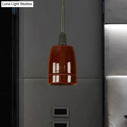 A glossy black red ceramic pendant light with an adjustable cord and sleek metallic stem for ceiling installation