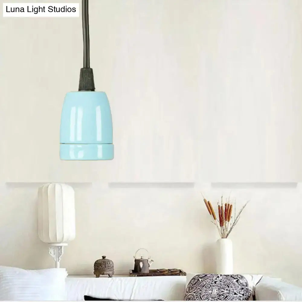 A sleek light blue ceramic pendant light with matte finish and black cord from decorbites black red ceramic collection