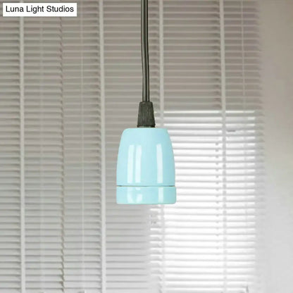 A sleek light blue ceramic pendant light with matte finish and black cord from decorbites black red ceramic line